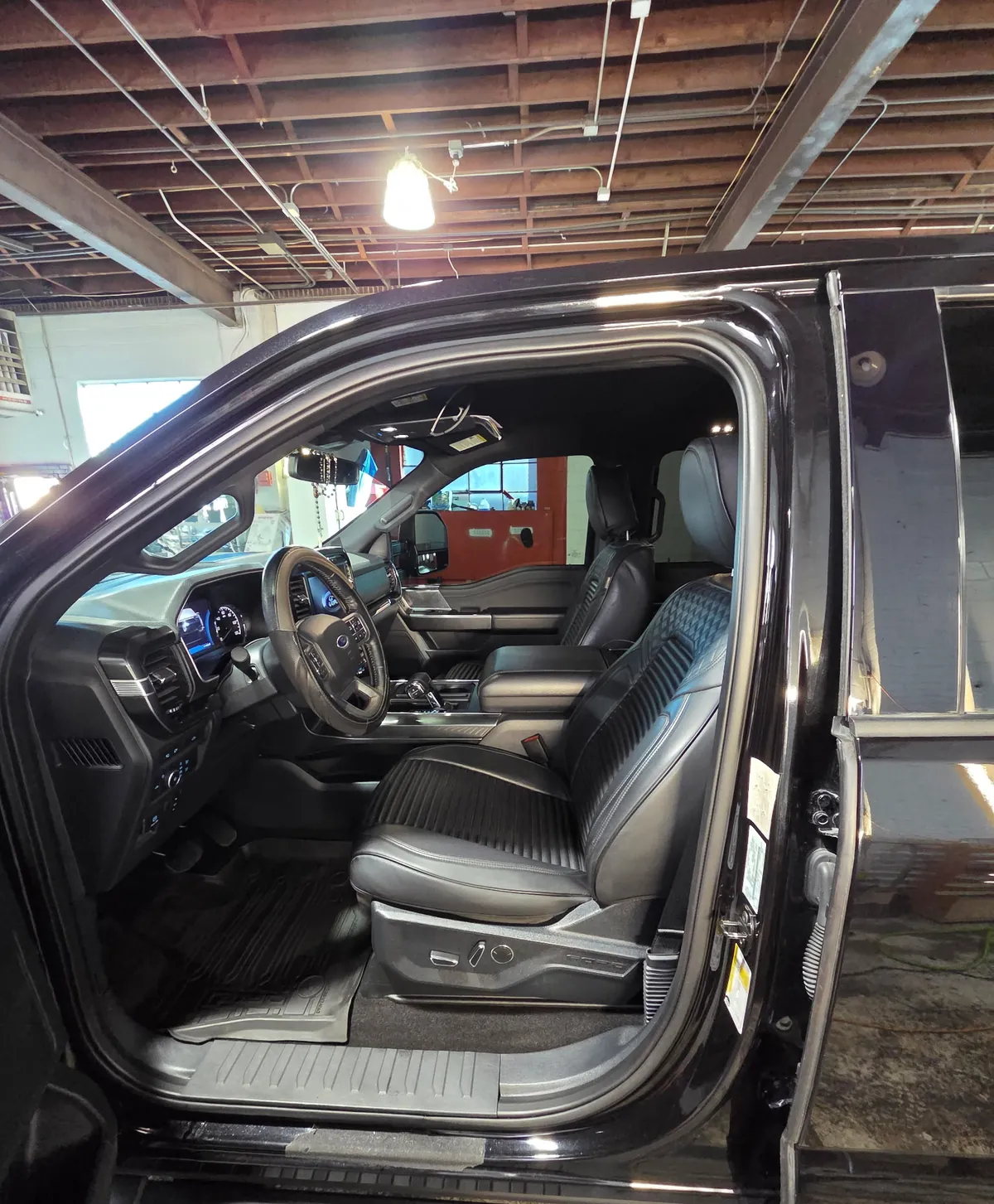 Open door of a Ford F-150 showing a clean cab