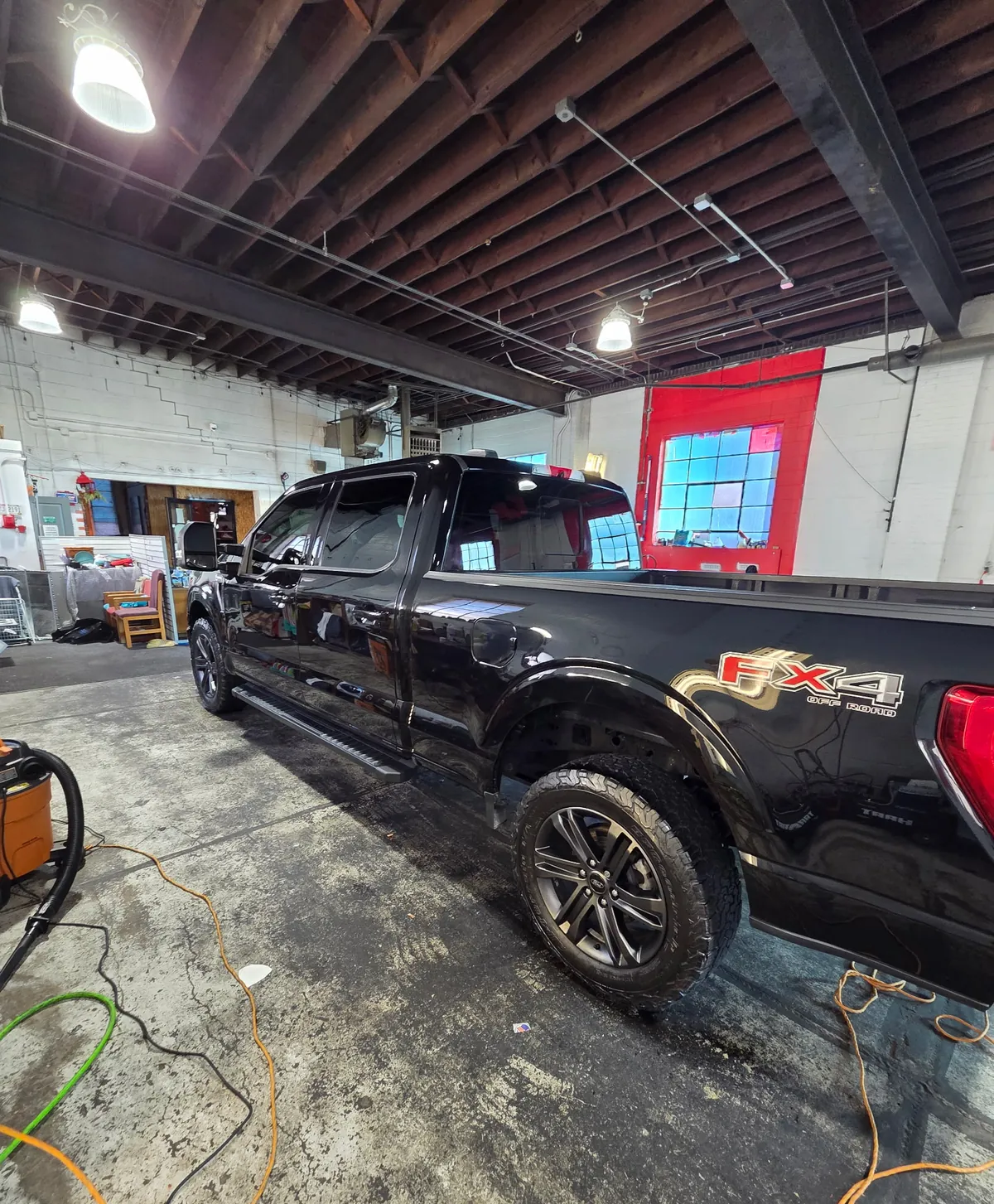 Black Ford F-150 FX4 shining inside the shop